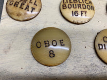 Load image into Gallery viewer, 13 ANTIQUE ORGAN STOP FACES, LABELS 1 1/4 IN DIAMETER - Boyshill Tools and Treen